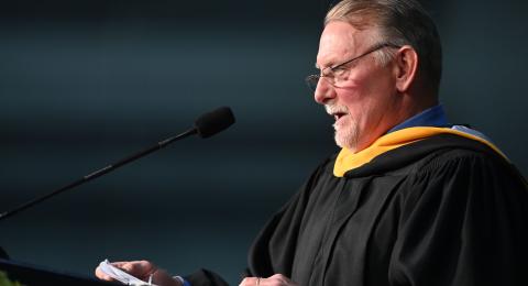 Faculty member giving a speech at commencement