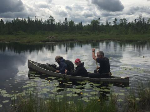 Len Reitsma, Sam Parks, and Autumn Heil in canoe on lake