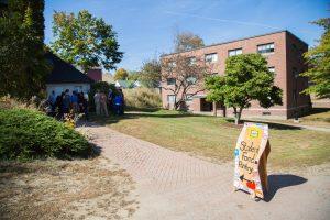 A stand up sign says, "Student Food Pantry," with an arrow pointing toward the Hartman Union Building on campus.