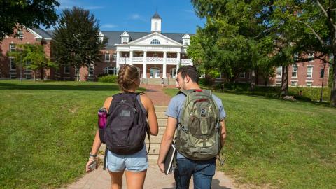 Two students walking next to each other on PSU campus