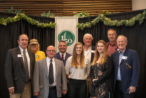 A group of people smiling at a celebration event