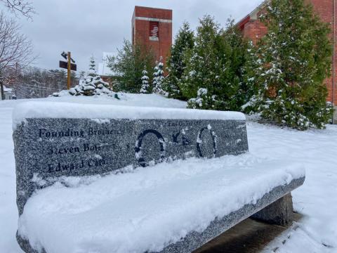 granite tribute bench on Plymouth campus in the winter